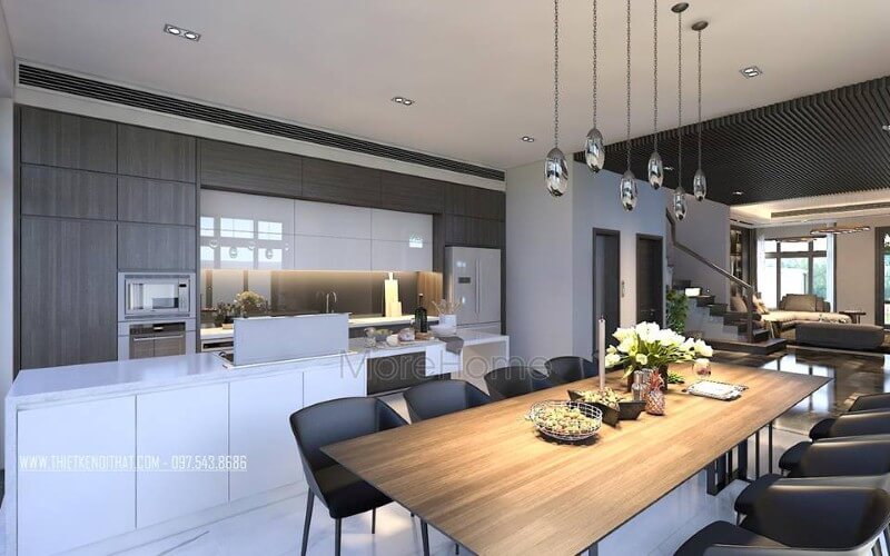 Bố trí nội thất phòng ăn liền bếp hiện đại, đẹp từ tủ bếp đảo kết hợp đá ốp cao cấp cùng bộ bàn ghế ăn gỗ nguyên tấm độc đáo. Thiết kế nội thất biệt thự tại Hà Nội